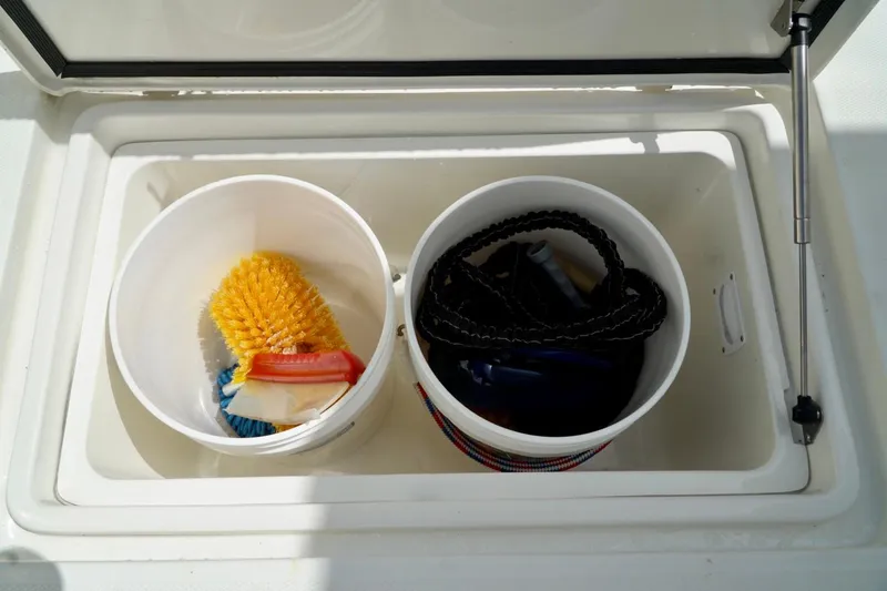 Slide: The Image of Storage compartment on 2017 SeaVee 34Z boat with cleaning supplies and rope. - 36
