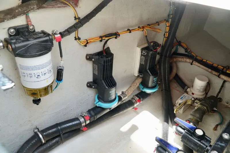 Slide: The Image of 2017 SeaVee 34Z boat engine compartment with pumps, filters, and wiring. - 41