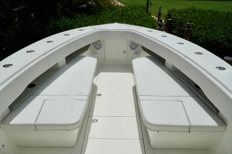 Slide: The Image of 2017 SeaVee 34Z boat interior with white cushioned seating and speaker system. - 58