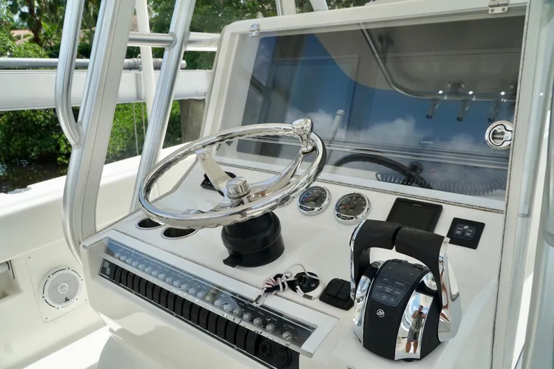 Slide: The Image of 2017 SeaVee 34Z boat helm with steering wheel and control panel. - 64