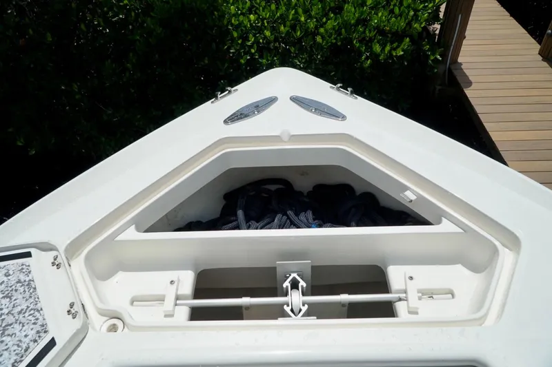 Slide: The Image of 2017 SeaVee 34Z boat anchor storage compartment with ropes, dockside view. - 69