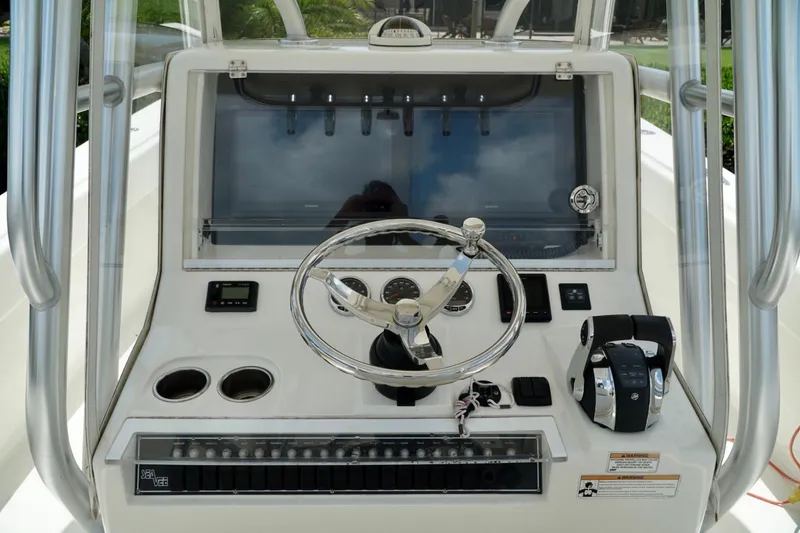 Slide: The Image of 2017 SeaVee 34Z boat helm with steering wheel and control panel. - 70