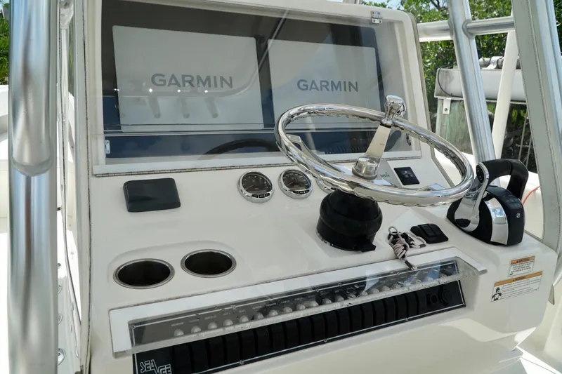 Slide: The Image of 2017 SeaVee 34Z boat helm with Garmin displays and chrome steering wheel. - 72