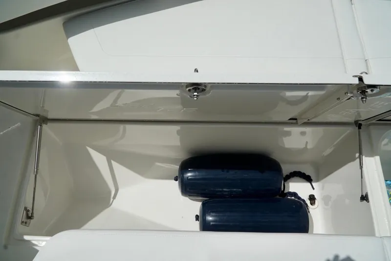 Slide: The Image of Storage compartment of 2017 SeaVee 34Z boat with blue fenders inside. - 76