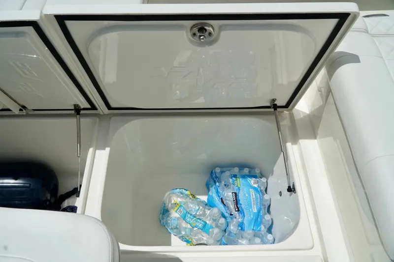 Slide: The Image of Open storage compartment on 2017 SeaVee 34Z boat with bottled water inside. - 77