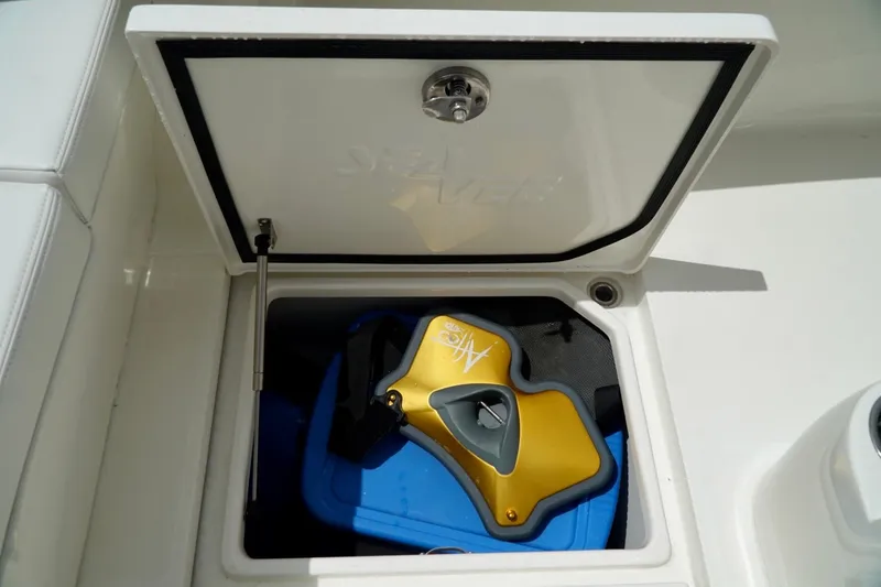 Slide: The Image of Storage compartment on 2017 SeaVee 34Z boat with yellow and blue equipment inside. - 78
