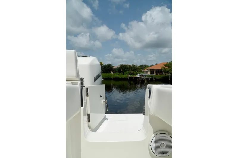 Slide: The Image of 2017 SeaVee 34Z boat with open door, overlooking serene waterfront and house. - 80
