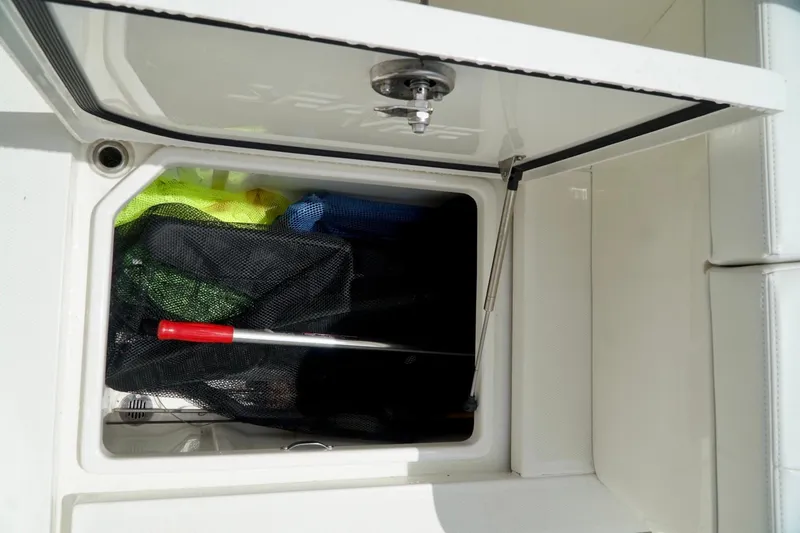 Slide: The Image of Storage compartment on a 2017 SeaVee 34Z boat with fishing gear inside. - 81
