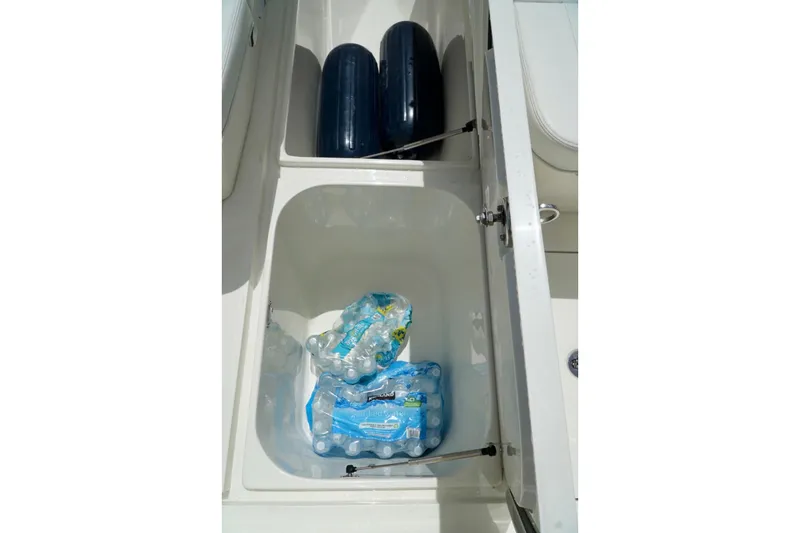 Slide: The Image of Storage compartments on a 2017 SeaVee 34Z boat with water bottles and fenders. - 82