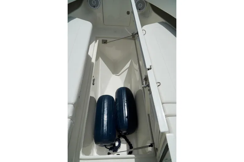 Slide: The Image of Open storage compartment on 2017 SeaVee 34Z boat with blue fenders inside. - 83