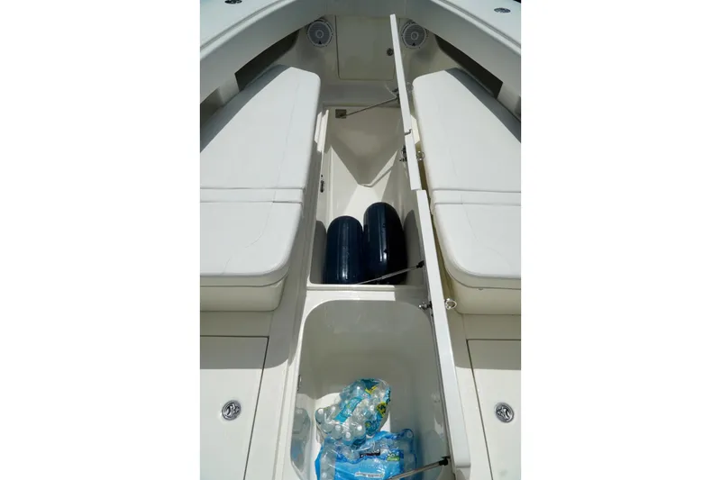 Slide: The Image of 2017 SeaVee 34Z boat interior storage with water bottles and fenders. - 85