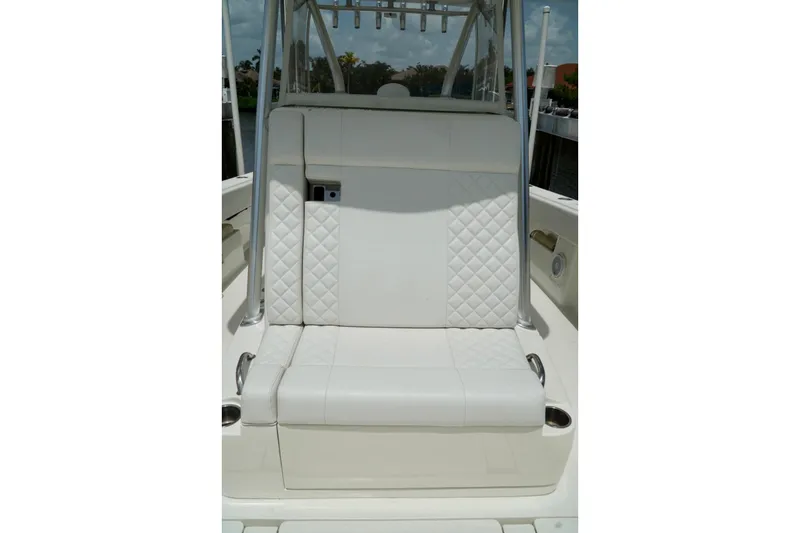 Slide: The Image of 2017 SeaVee 34Z boat seat with white quilted upholstery and cup holders. - 87