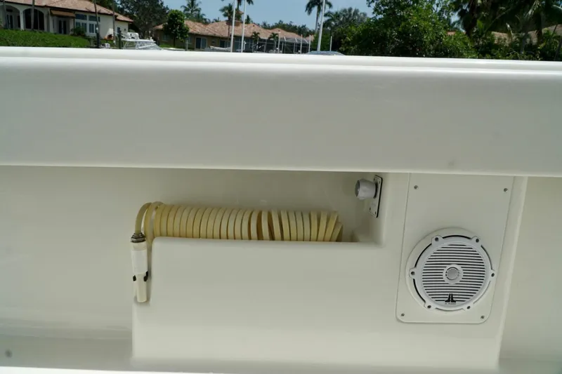 Slide: The Image of 2017 SeaVee 34Z boat deck with coiled hose and speaker. - 89