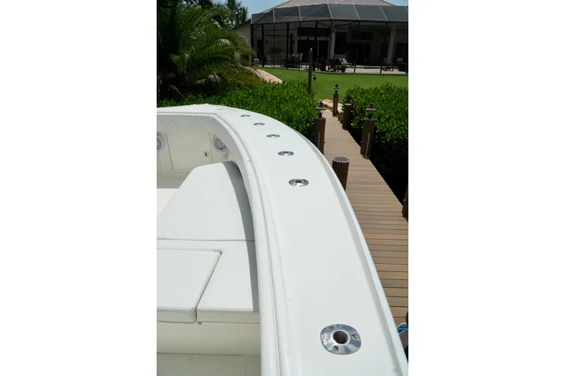 Slide: The Image of 2017 SeaVee 34Z boat bow with dock and lush greenery in background. - 92