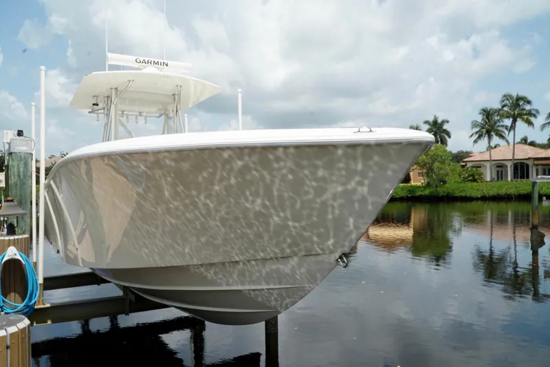 Slide: The Image of 2017 SeaVee 34Z boat docked by waterfront homes, reflecting on calm water. - 97