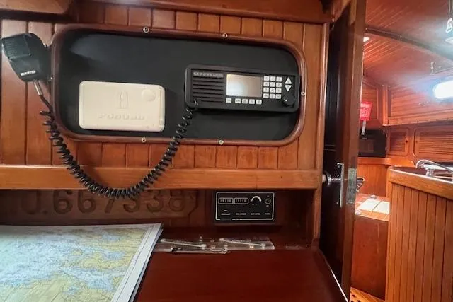 Slide: The Image of Interior of a 1983 Baba 40 sailboat featuring navigation equipment and a nautical chart. - 19
