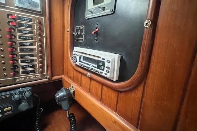 Slide: The Image of Control panel of a 1983 Baba 40 boat with radio and switches. - 21