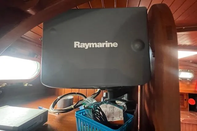 Slide: The Image of Raymarine equipment inside a 1983 Baba 40 sailboat cabin, featuring wooden interior details. - 22