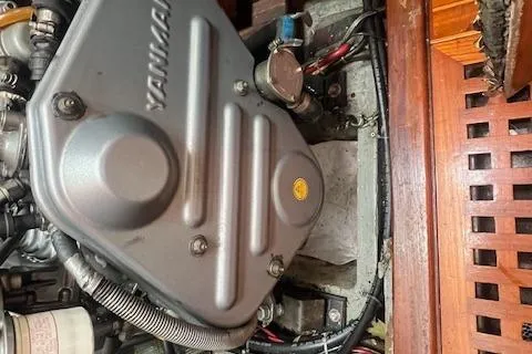 Slide: The Image of Engine compartment of a 1983 Baba 40 sailboat with visible Yanmar engine components. - 25