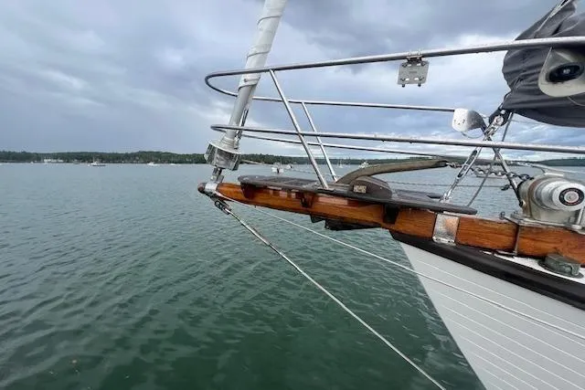 Slide: The Image of Sailboat bow on water, Baba 40 model, 1983, with cloudy sky background. - 29