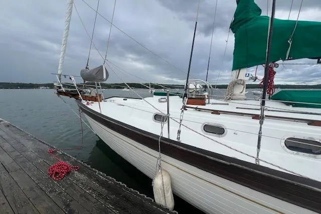 Slide: The Image of Sailboat docked at pier, Baba 40 model, 1983, with green sail cover. - 30