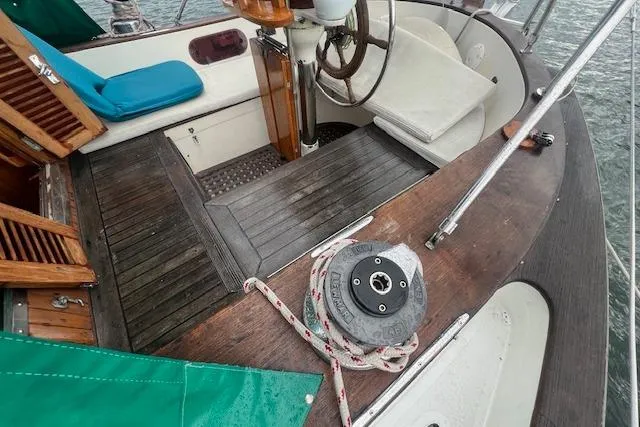 Slide: The Image of Cockpit of a 1983 Baba 40 sailboat with wooden deck and steering wheel. - 39