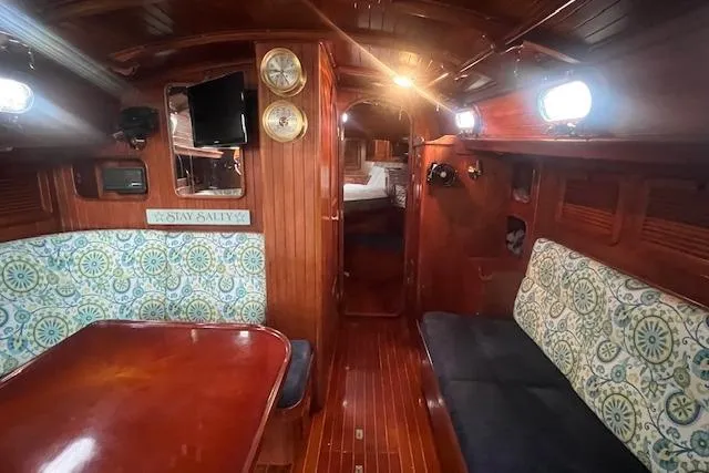Slide: The Image of Interior of 1983 Baba 40 sailboat with wooden finish and patterned seating. - 5