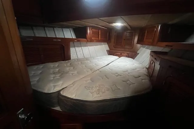 Slide: The Image of Cozy cabin interior of a 1983 Baba 40 sailboat with a comfortable bed. - 7