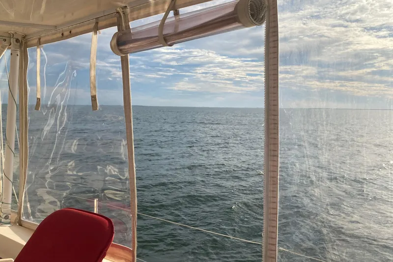 Slide: The Image of View from 2005 Island Packet 485 sailboat, overlooking serene ocean and sky. - 12