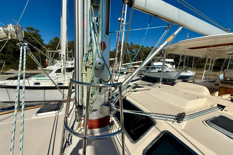 Slide: The Image of 2005 Island Packet 485 sailboat deck with rigging and nearby boats in marina. - 13