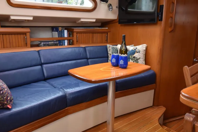 Slide: The Image of Luxurious interior of 2005 Island Packet 485 yacht with blue seating and wooden table. - 17