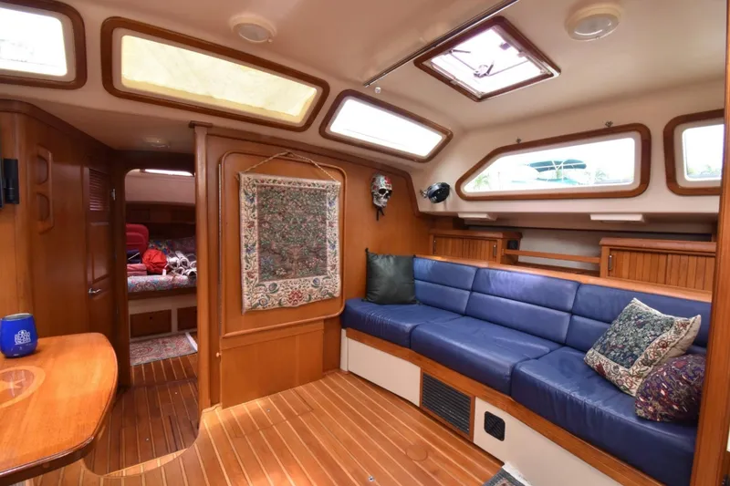 Slide: The Image of Luxurious 2005 Island Packet 485 yacht interior with blue seating and wooden accents. - 19