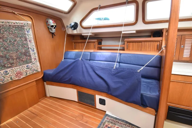 Slide: The Image of Interior of 2005 Island Packet 485 yacht with blue seating and wooden accents. - 20