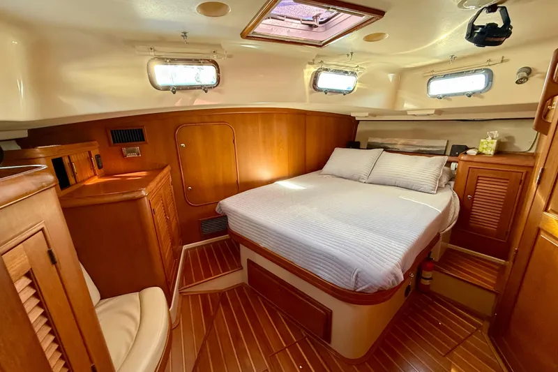 Slide: The Image of Luxurious cabin interior of 2005 Island Packet 485 yacht with wood finish and cozy bed. - 23
