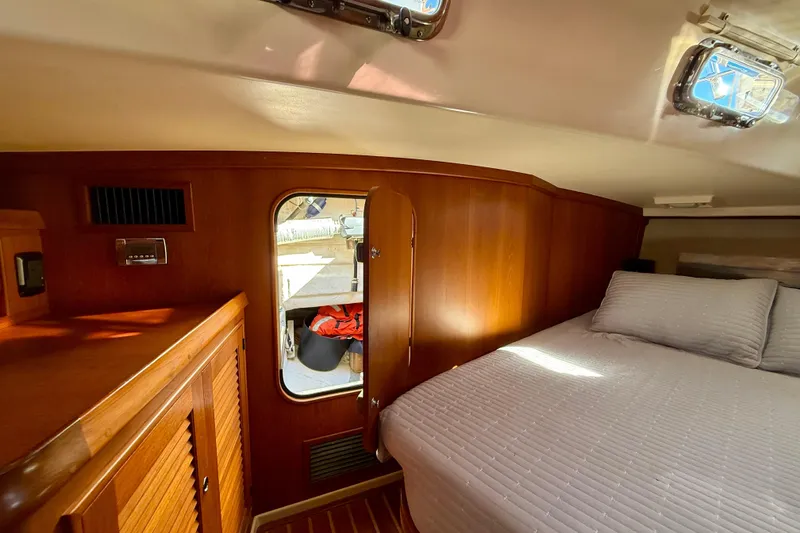 Slide: The Image of Luxurious cabin interior of 2005 Island Packet 485 yacht with cozy bed and wooden finish. - 24