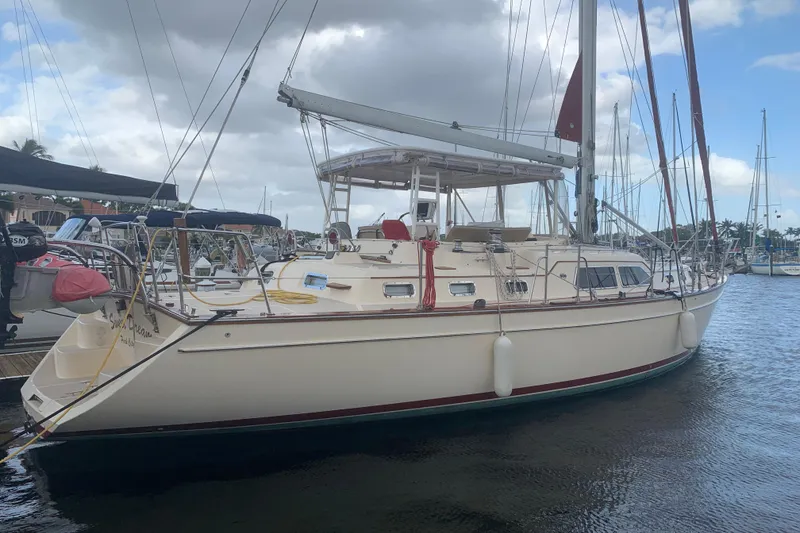 Slide: The Image of 2005 Island Packet 485 sailboat docked in a marina under cloudy skies. - 3