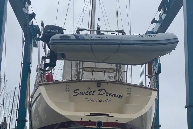Slide: The Image of Island Packet 485 sailboat from 2005 with dinghy, named "Sweet Dream," in Deltaville, VA. - 32