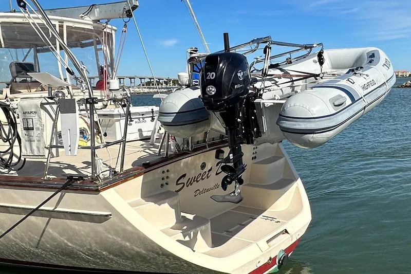 Slide: The Image of 2005 Island Packet 485 sailboat with dinghy and outboard motor on the stern. - 4