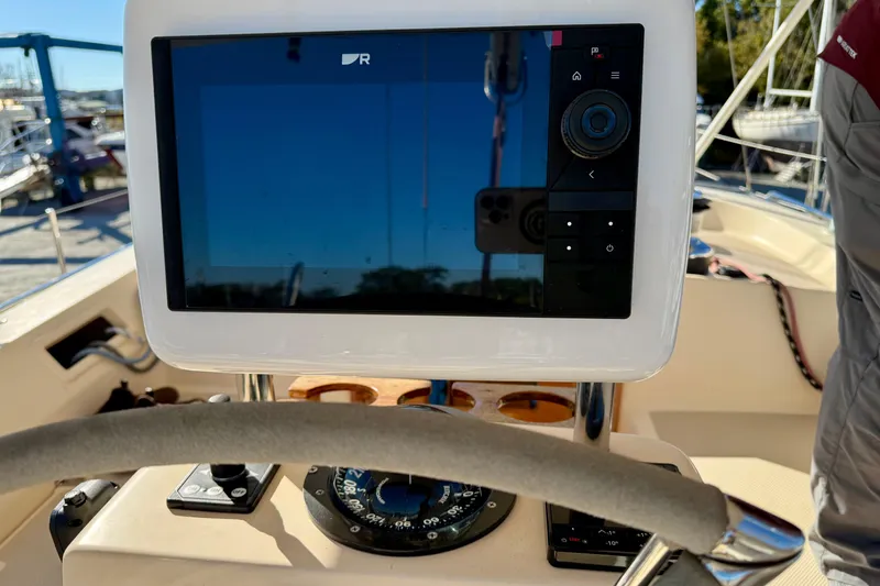 Slide: The Image of Helm of 2005 Island Packet 485 sailboat with navigation display and compass. - 8