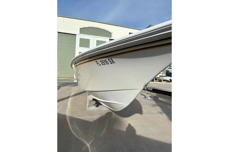 Slide: The Image of 1998 Fountain 35 Lightning boat, white hull, docked outdoors under clear sky. - 5