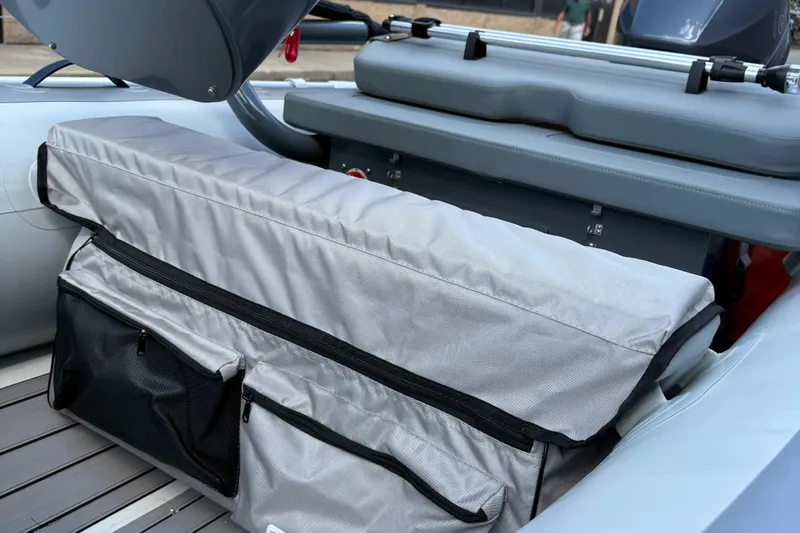 Slide: The Image of 2025 Highfield CL310 FCT boat interior with gray seating and storage compartments. - 6