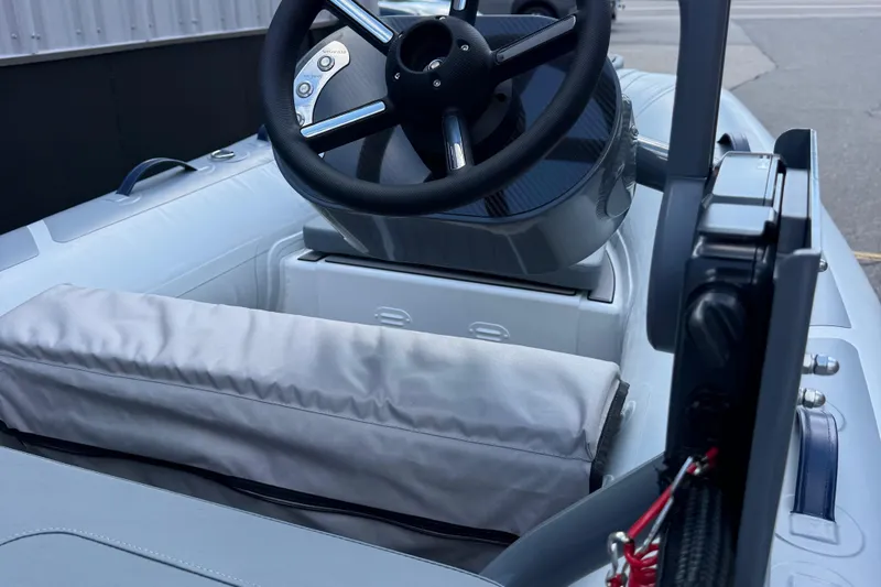 Slide: The Image of 2025 Highfield CL310 FCT boat interior with steering wheel and cushioned seating. - 8