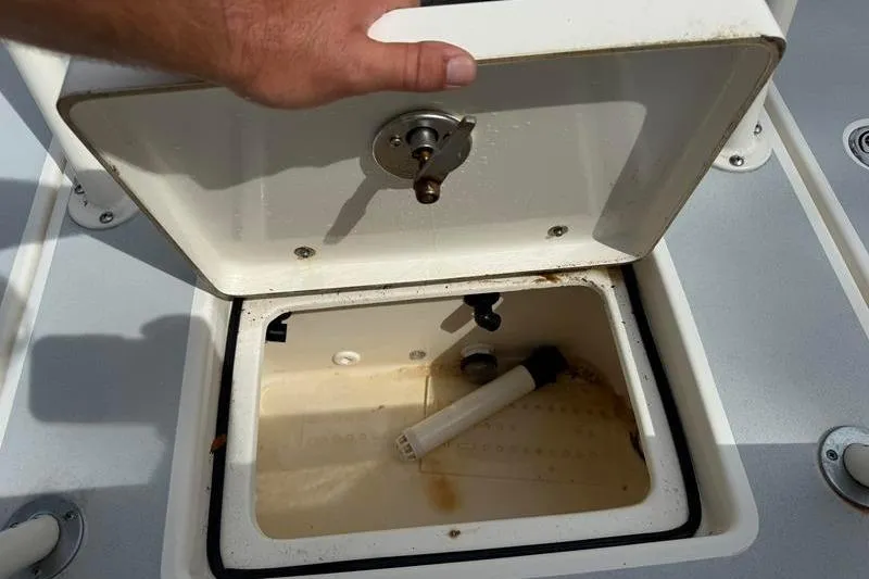 Slide: The Image of Open storage compartment on 2013 Hewes Redfisher 18 boat, showing interior details. - 11