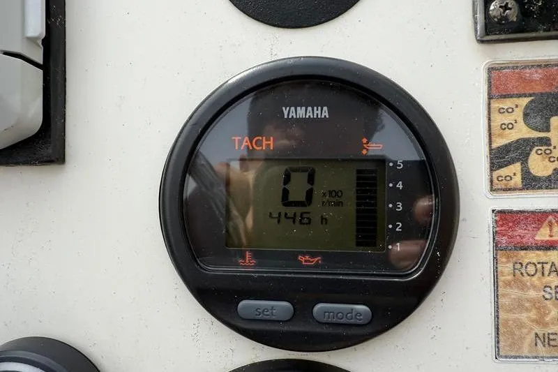 Slide: The Image of Yamaha tachometer on 2013 Hewes Redfisher 18 boat, displaying 446 hours. - 13