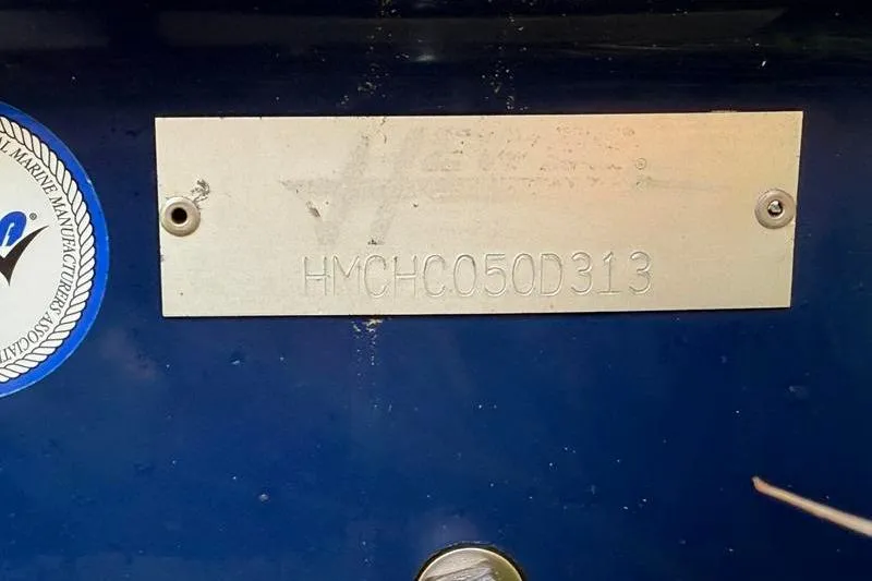 Slide: The Image of 2013 Hewes Redfisher 18 boat identification plate with serial number on blue background. - 16