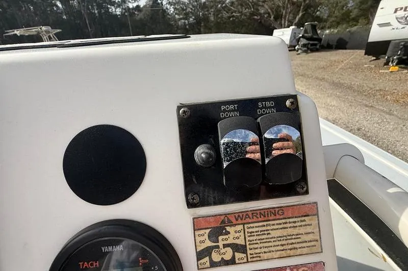 Slide: The Image of 2013 Hewes Redfisher 18 boat controls with warning label and Yamaha tachometer. - 23