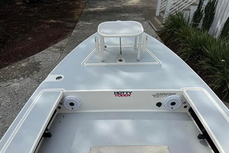Slide: The Image of 2013 Hewes Redfisher 18 boat deck with seating and storage compartments. - 6