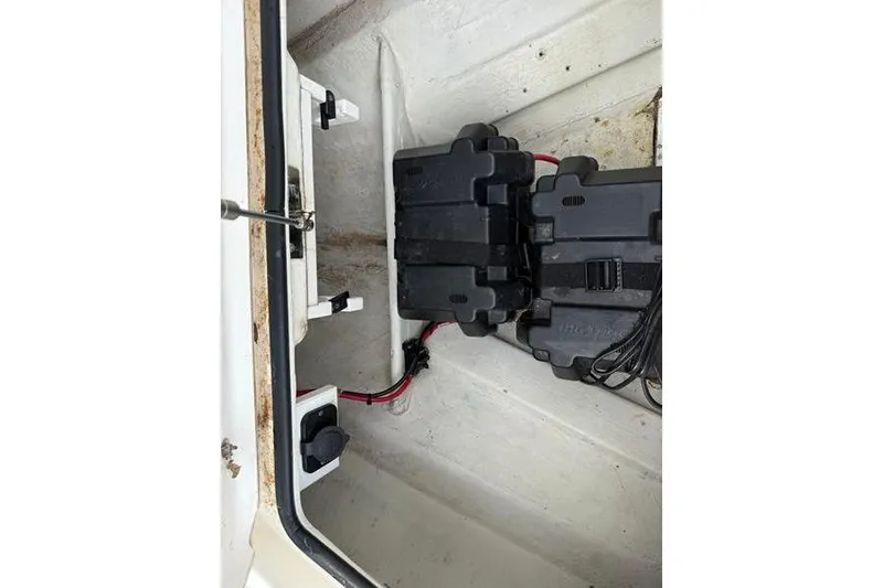 Slide: The Image of 2013 Hewes Redfisher 18 boat interior with battery compartment and wiring. - 7