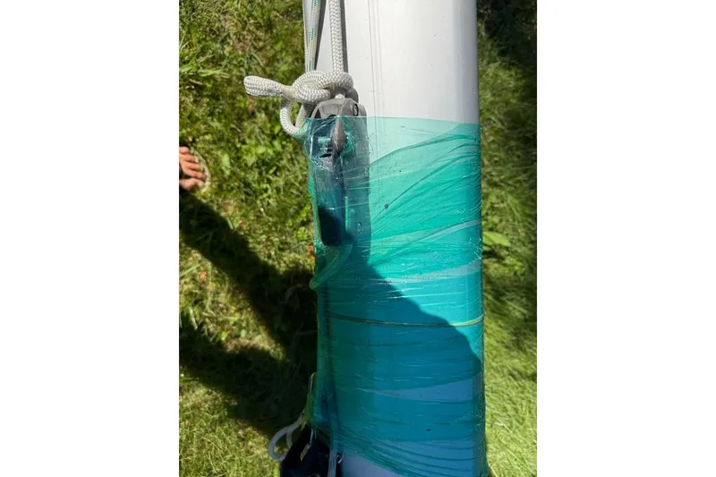 Slide: The Image of Close-up of a 2007 Hallett 33 boat mast wrapped in green tape. - 20