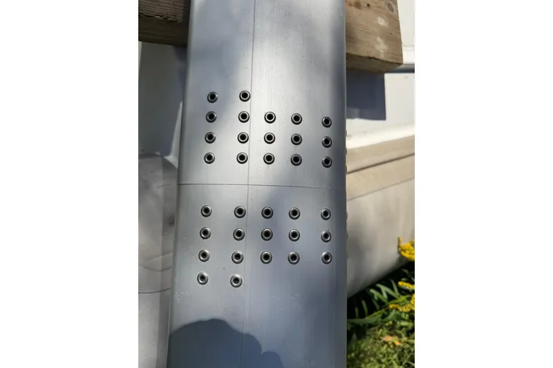 Slide: The Image of Close-up of a 2007 Hallett 33 boat's metallic surface with rivet details. - 23